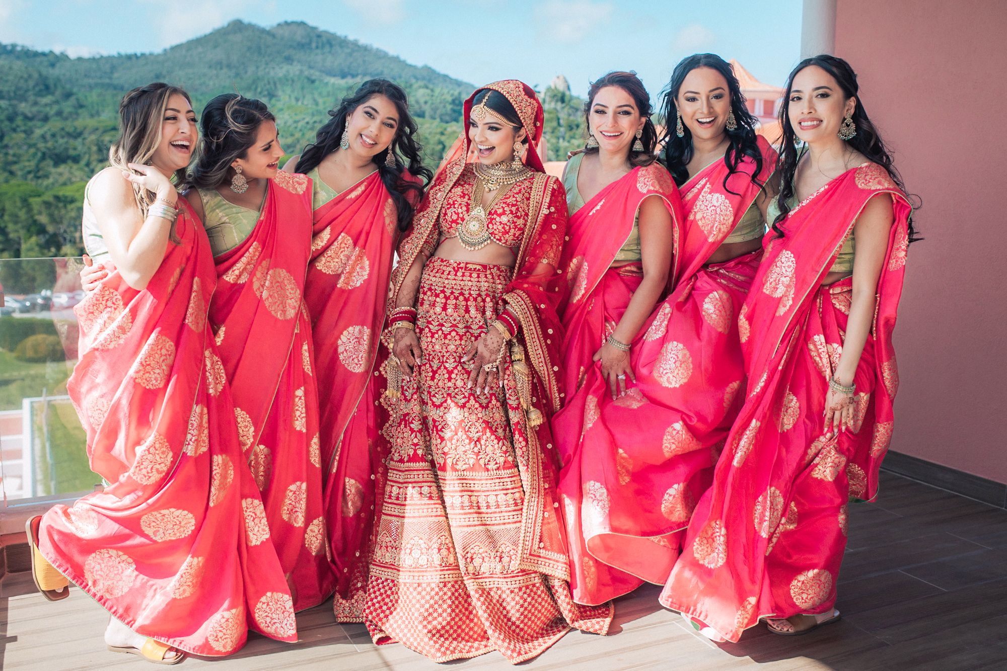 Bridesmaids in colorful sarees celebrating, photographed by an Indian destination wedding photographer in Portugal – Penha Longa Resort