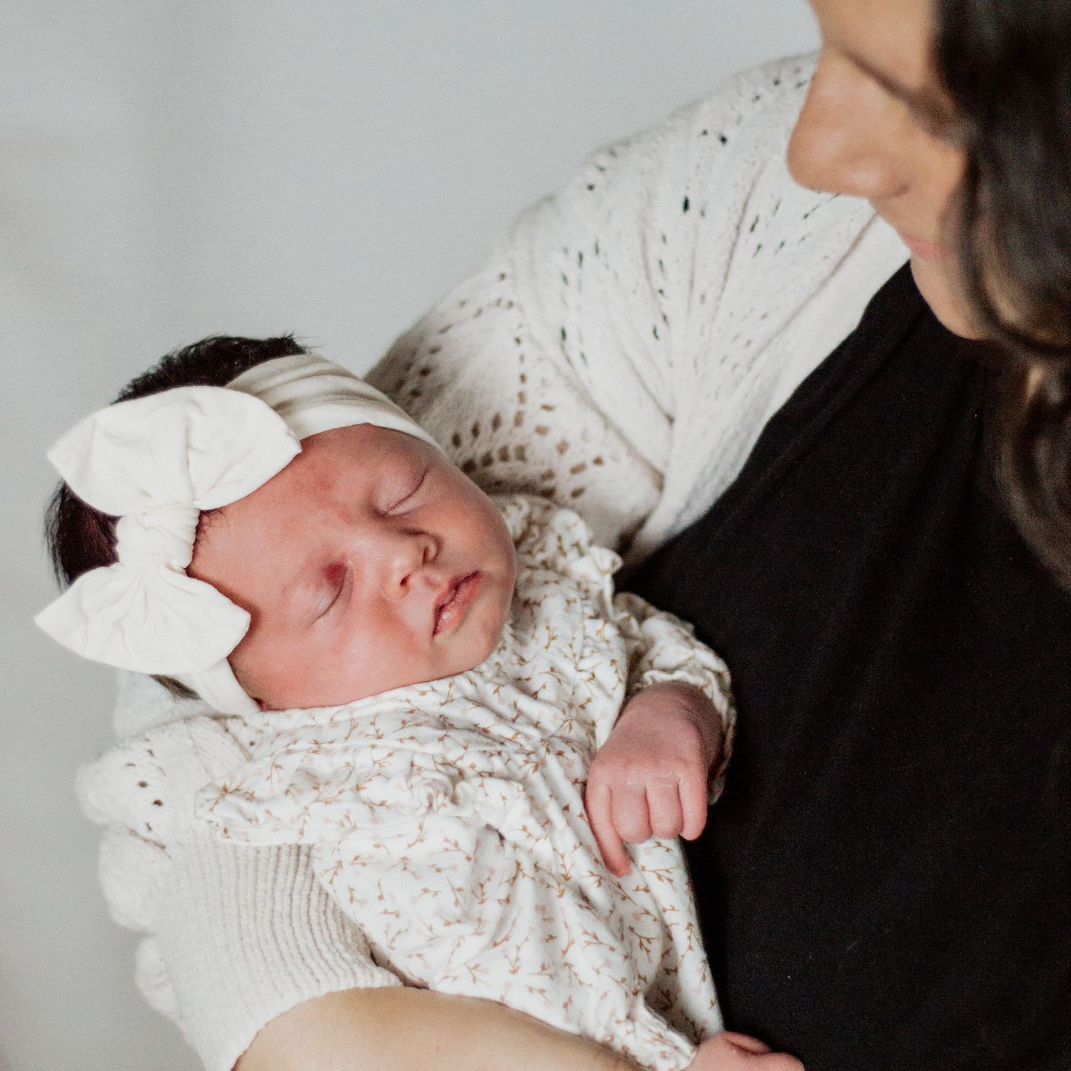 A mother gazes lovingly at her newborn baby girl in Wellsville, NY. Captured by M. Rose Photography.