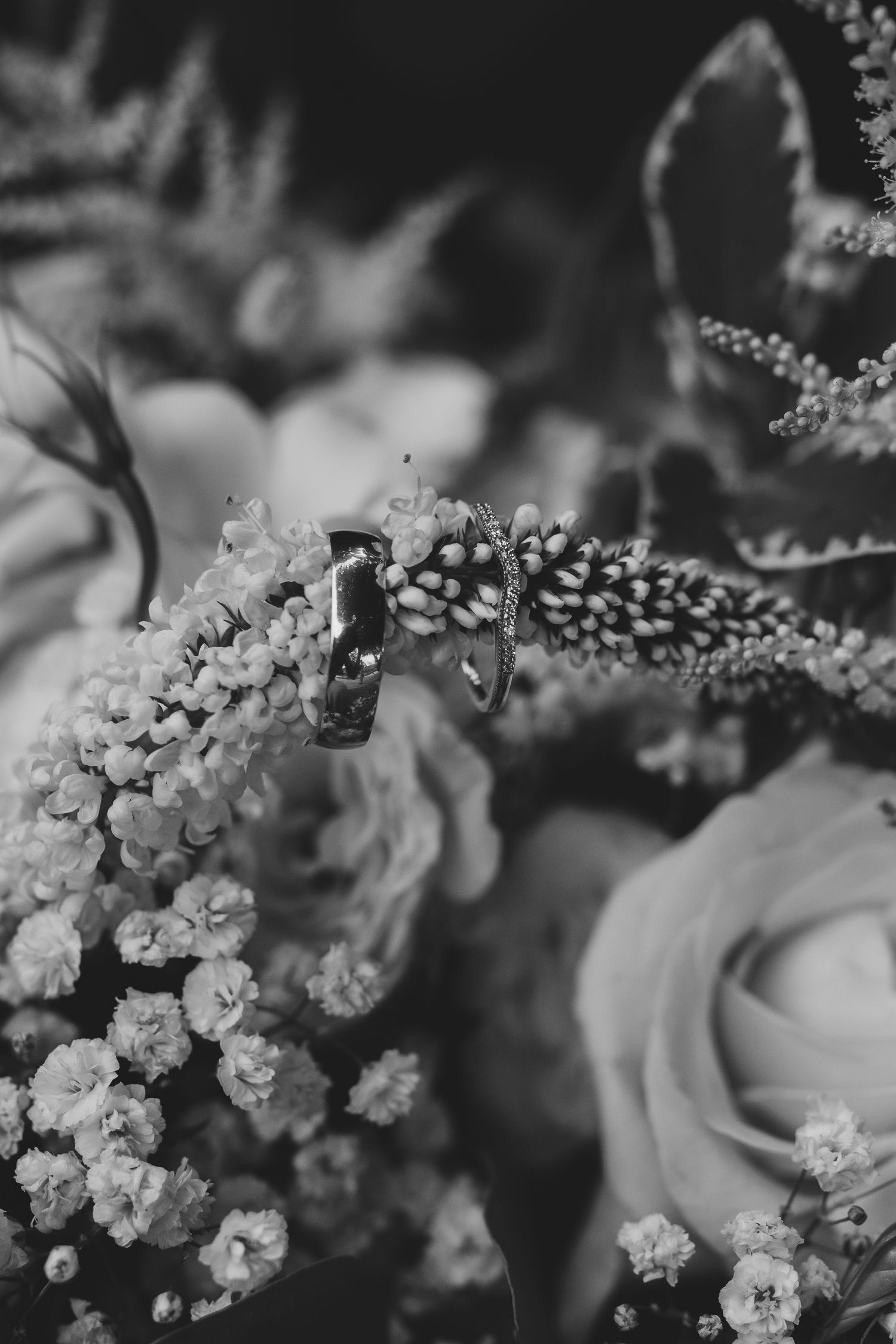 Close-up of wedding rings, bouquet and bridal details, captured with natural light.