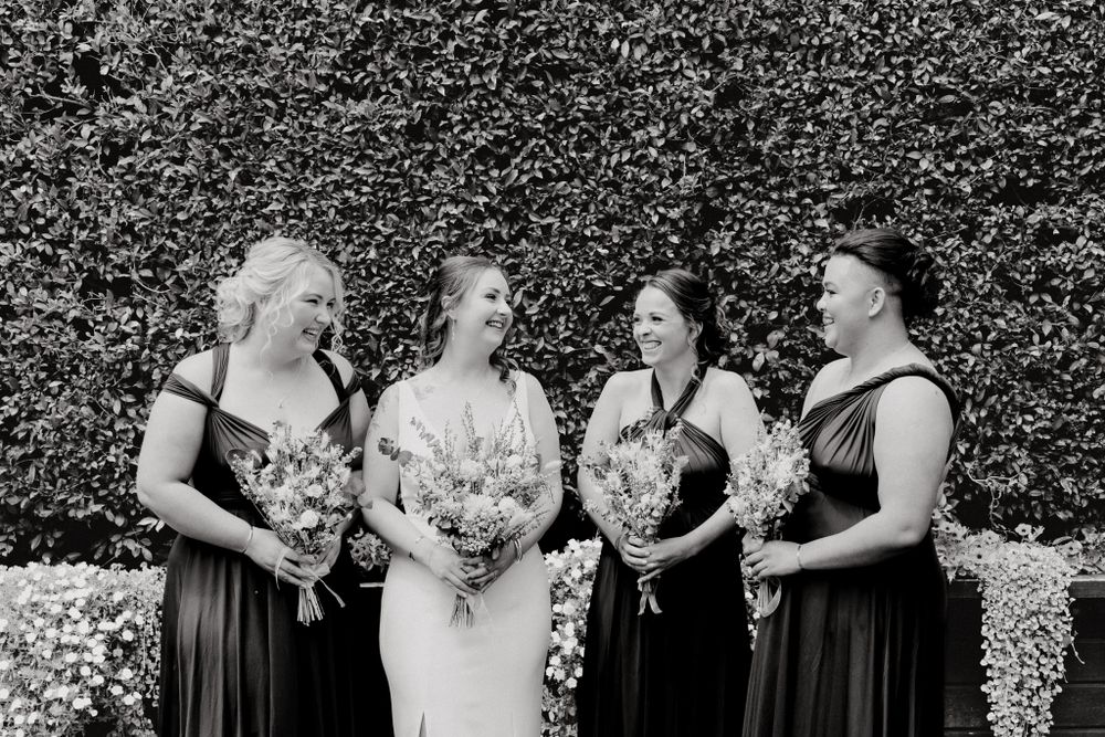 The girls share a candid moment after the First Look, captured by Apertured Media Auckland Wedding Photographer.