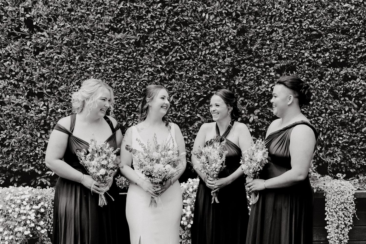The girls share a candid moment after the First Look, captured by Apertured Media Auckland Wedding Photographer.