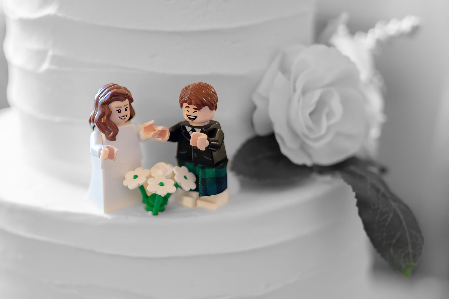 lego people decorate a wedding cake