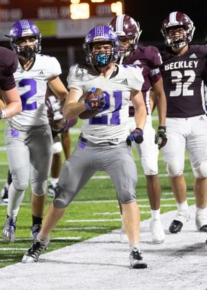 Football player celebrates between plays during game against Beckley team.