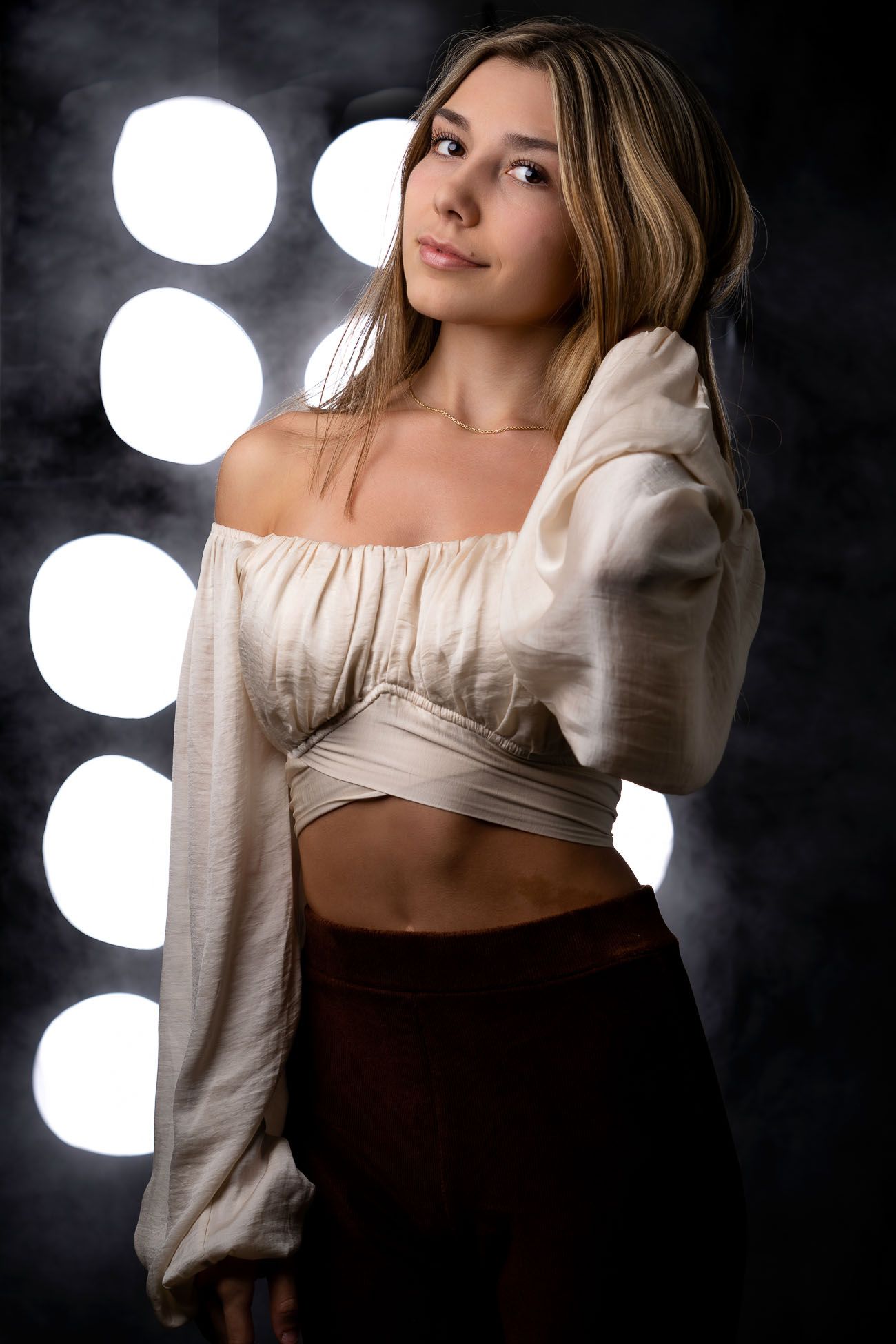 High school senior portrait in studio with dramatic lighting photographed in Summerville, South Carolina