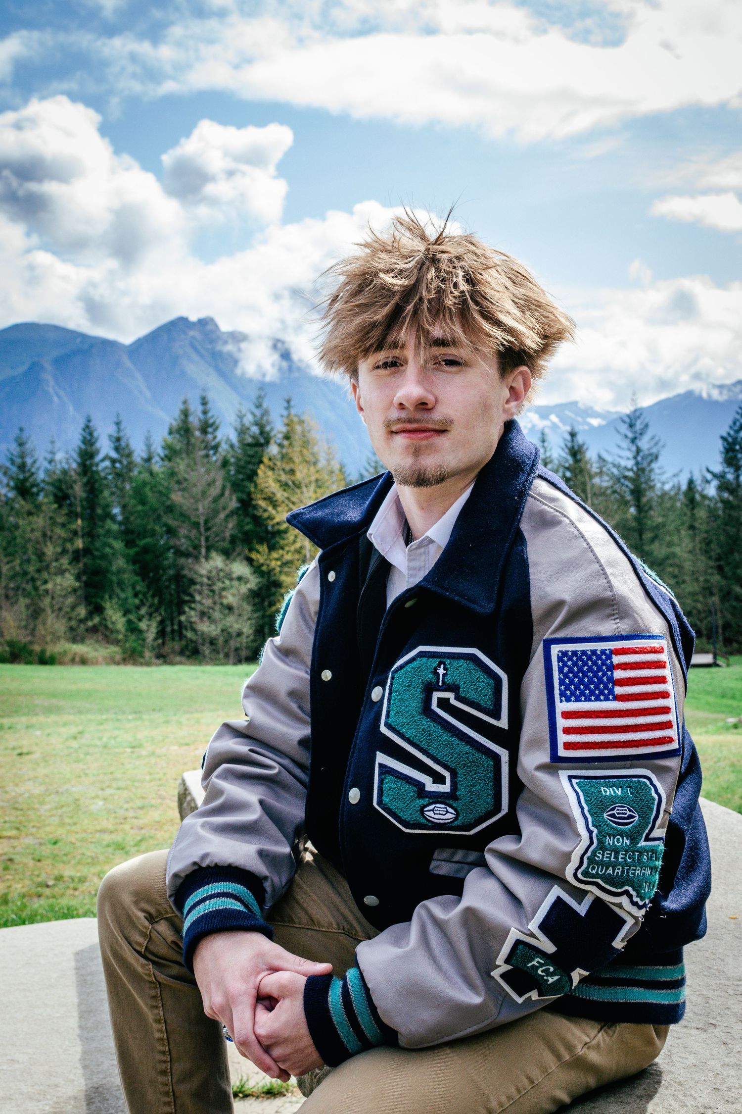 Senior graduation portrait with mountain backdrop at Snoqualmie Point Park an hour outside of Seattle, WA.