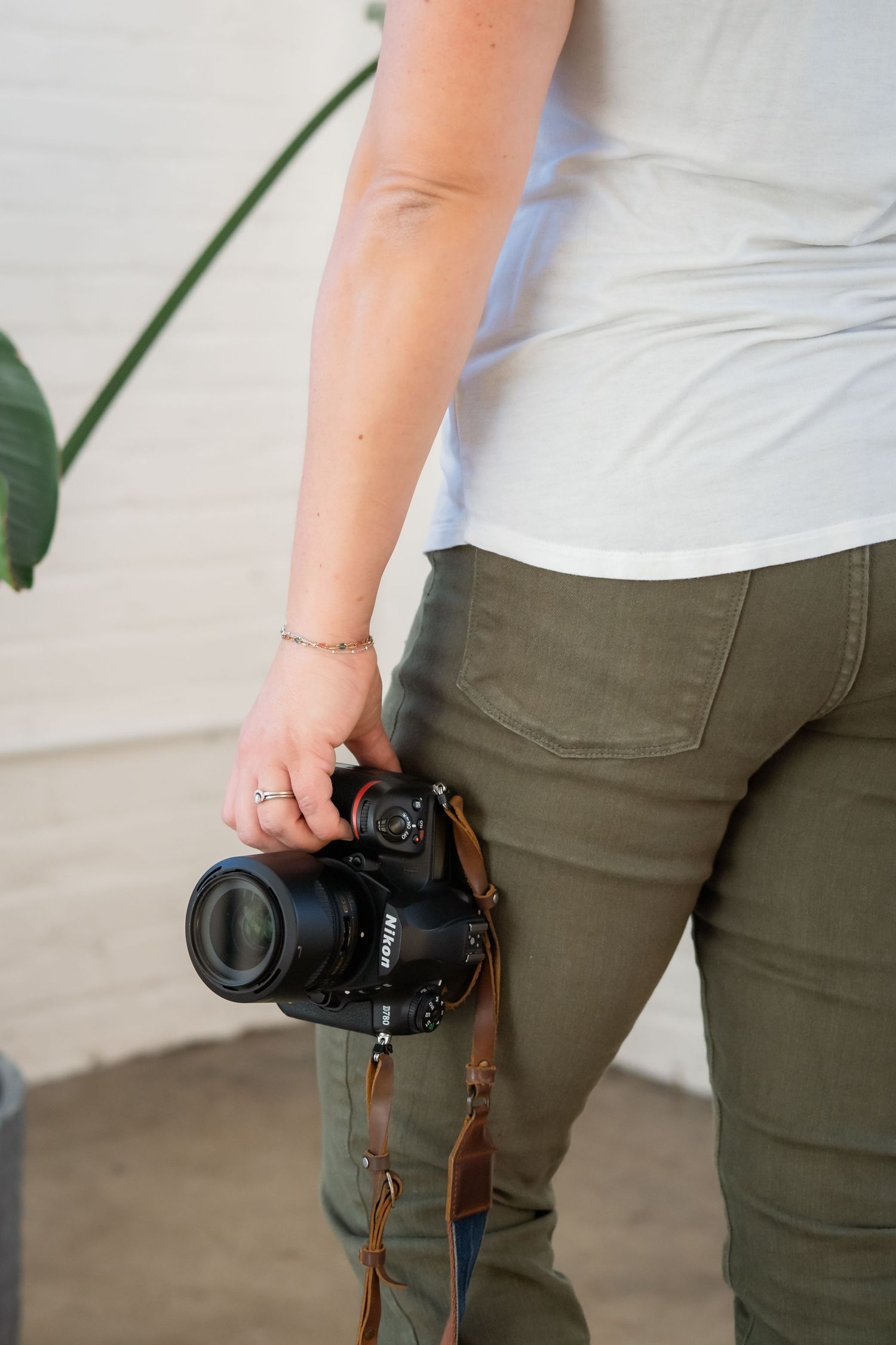 A sequence showing a camera being held at different angles against olive green pants in a white room setting.