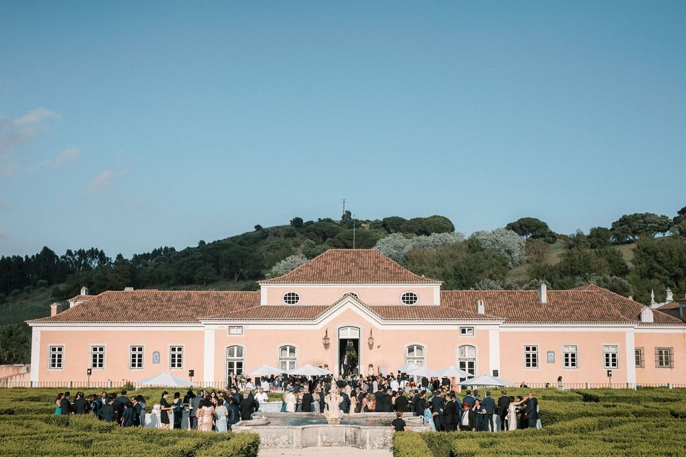 Guests gathered in the gardens of Palácio do Correio-Mor during luxury wedding reception in Portugal