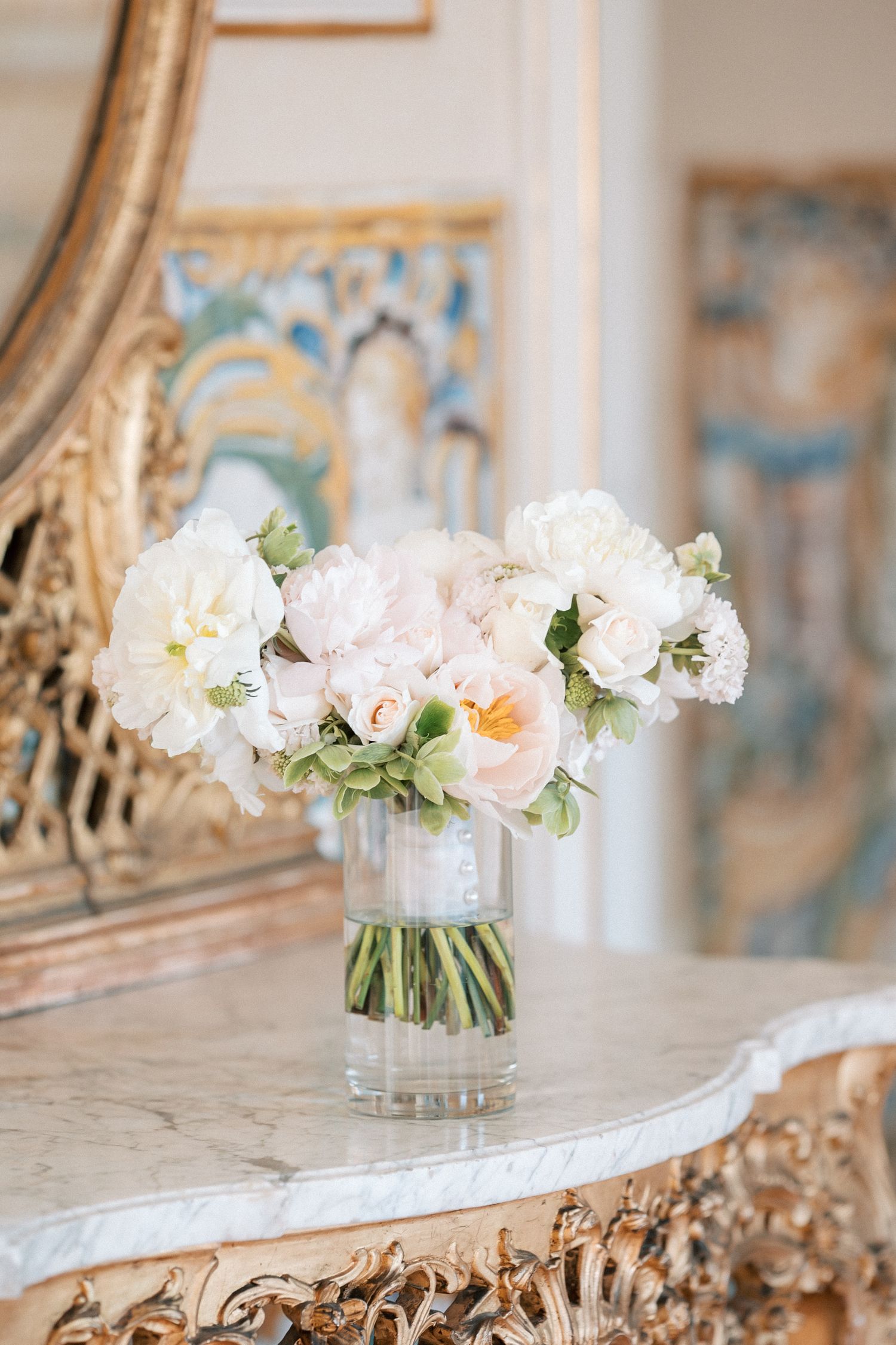 Bridal bouquet with white and blush flowers on marble table, Lisbon destination wedding details