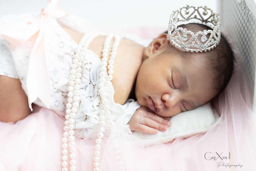 Newborn baby wearing a delicate lace crown sleeps peacefully on soft pink fabric in an artistic photo collage.