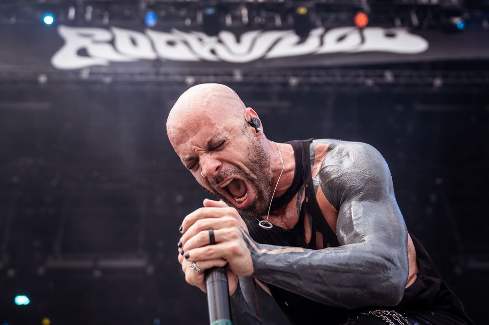 A collage of five dark concert photos showing performers on stage with dramatic lighting and emotional expressions.