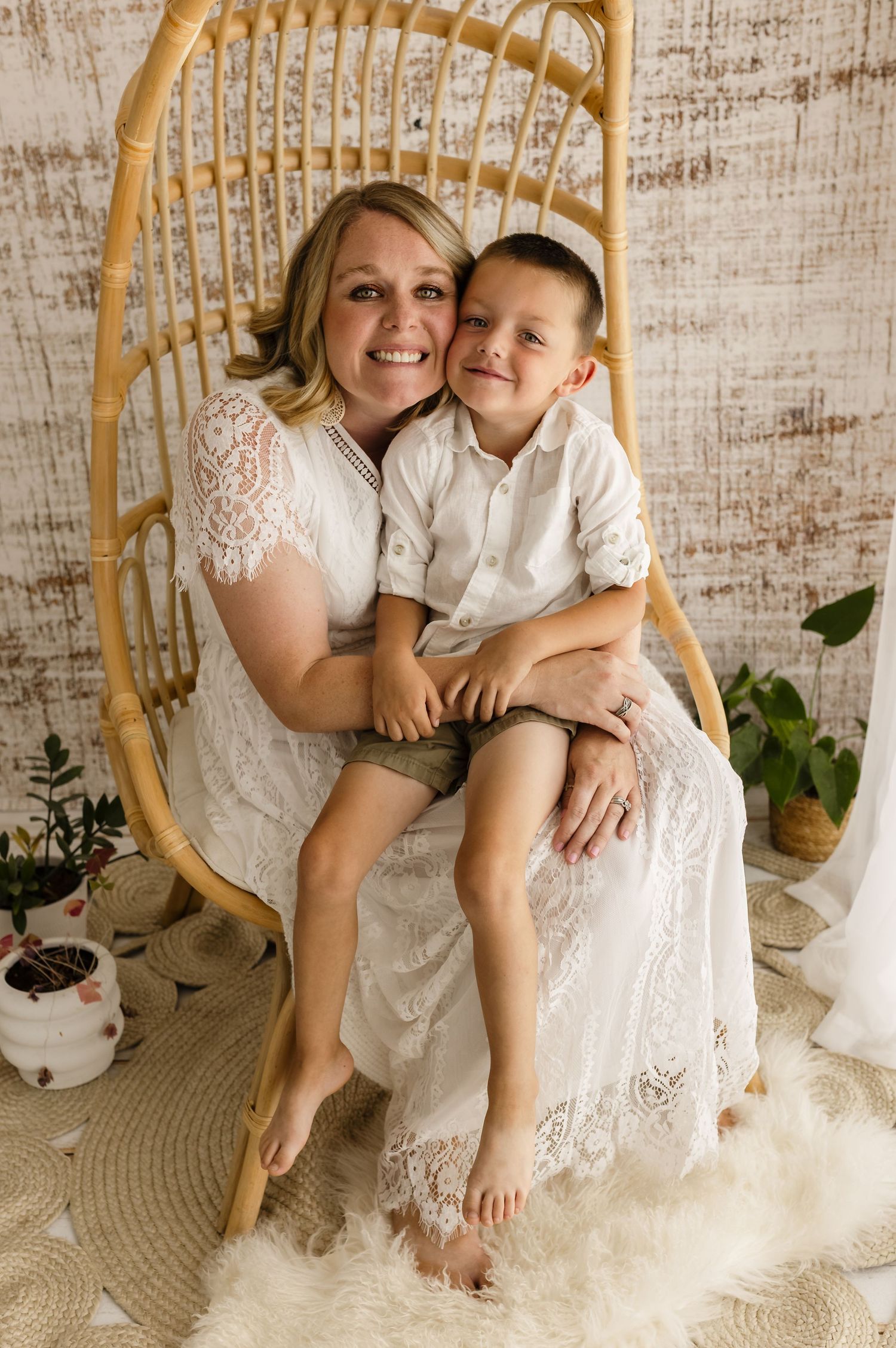 Mom and boy snuggle together, seated in a boho chair, captured by Charlottesville maternity and family photographer, Somerset Portraits.