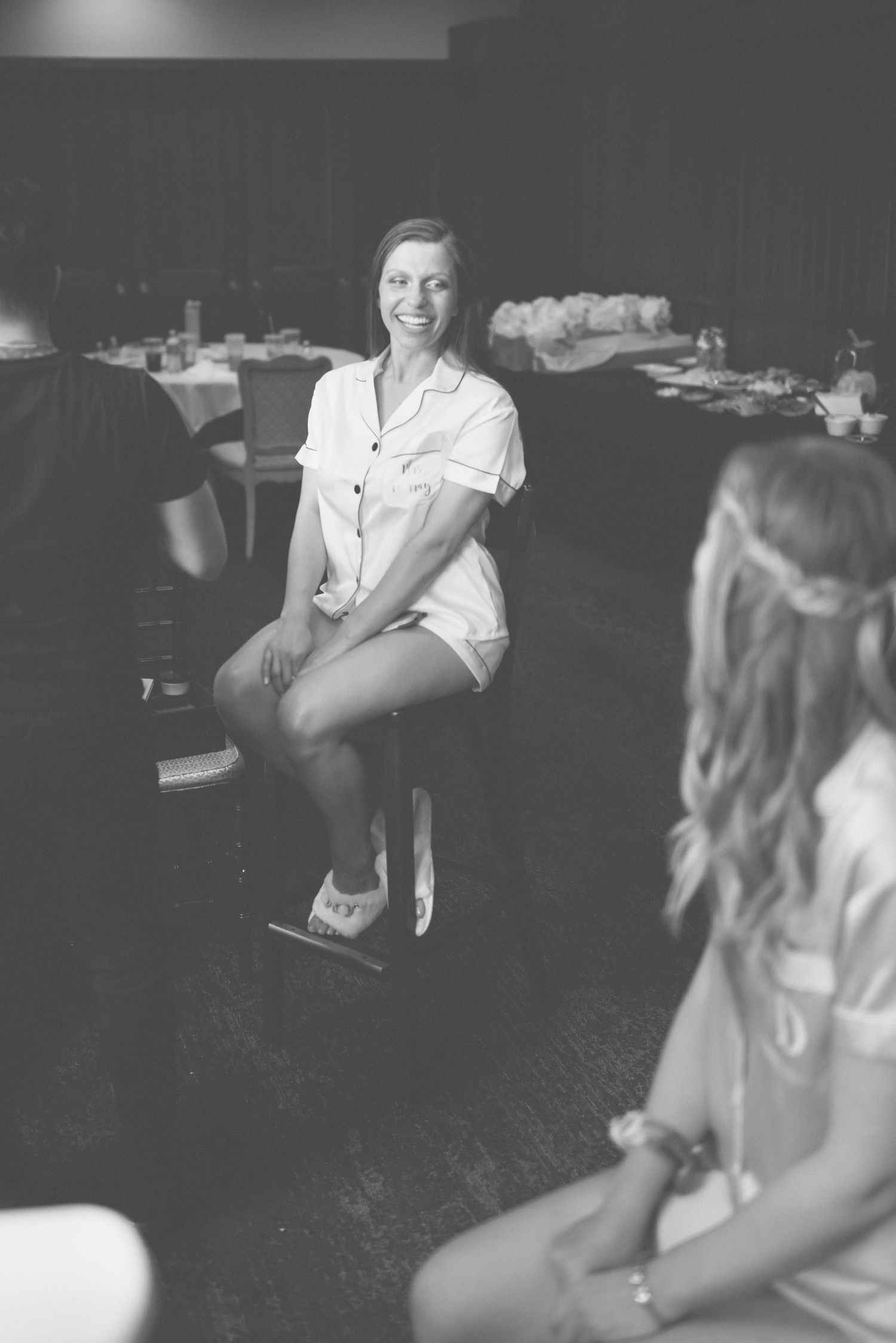 Black and white photo of wedding guests dancing at a reception.
