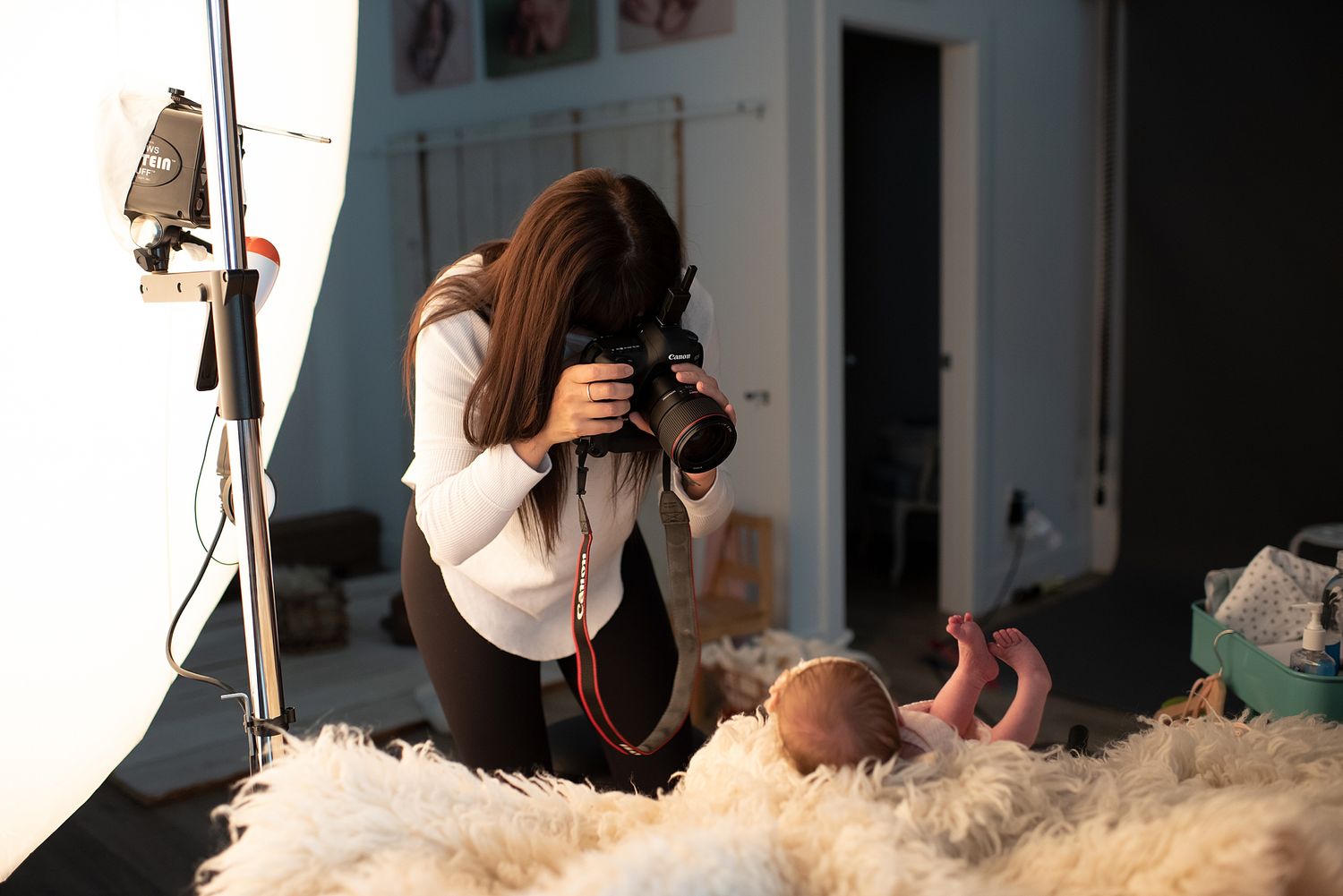 Professional photographer taking newborn pictures in a studio in calgary alberta