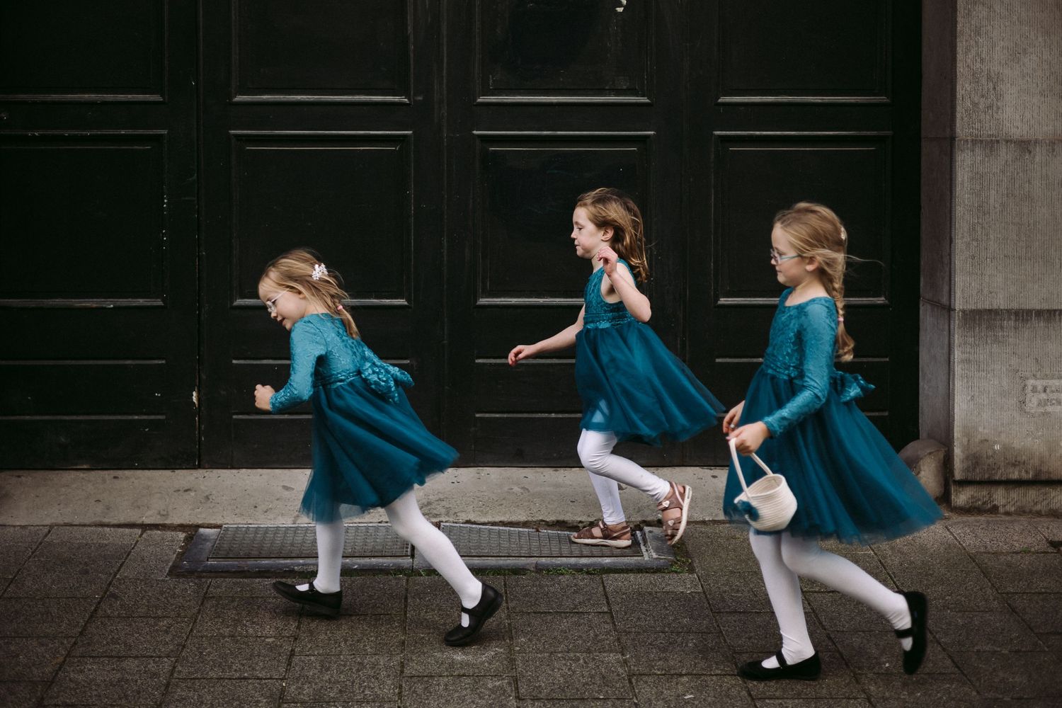 A series of images shows a figure in a blue dress performing graceful dance movements against a dark wall.