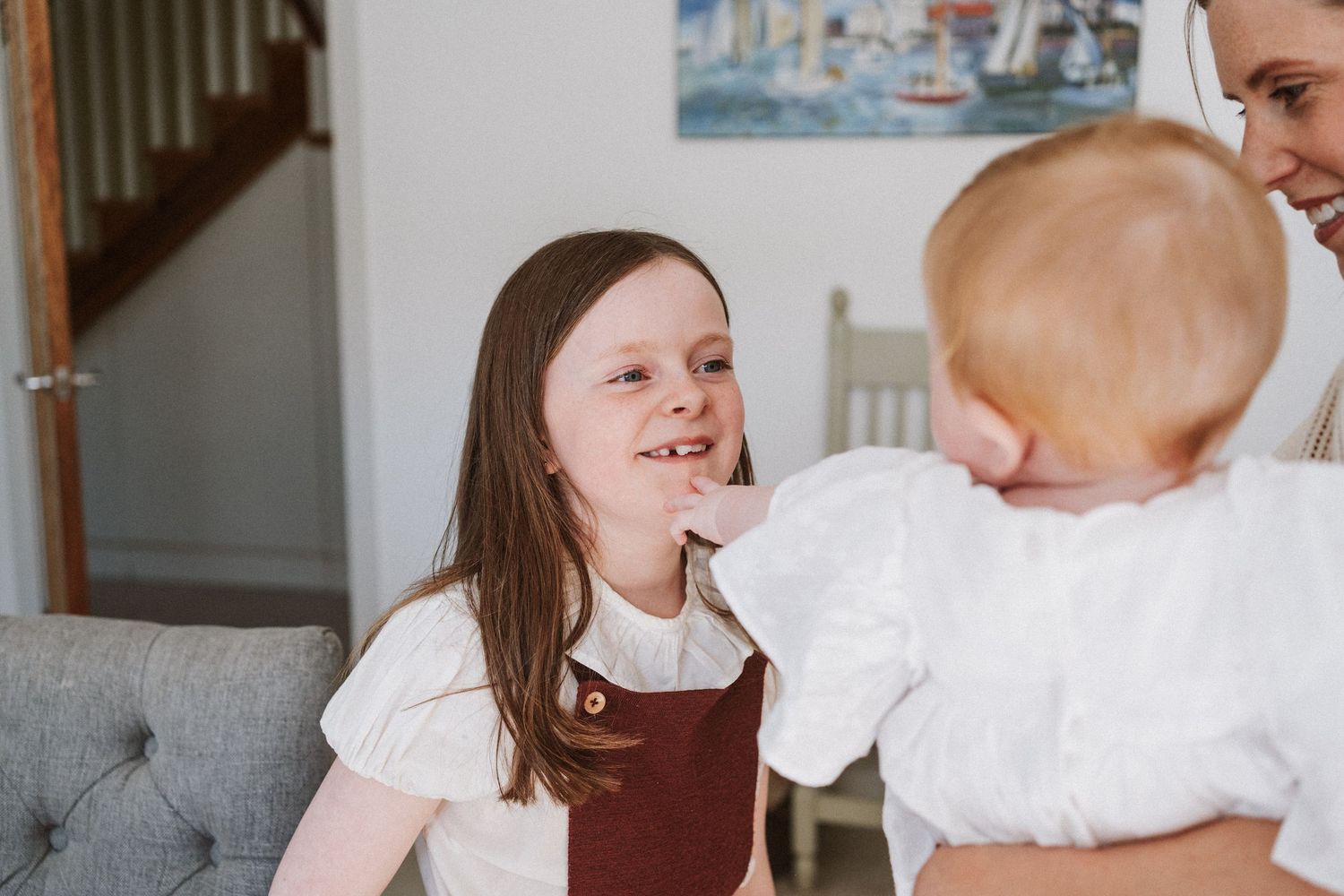 A collection of four candid family moments showing parents and children sharing joyful interactions at home.
