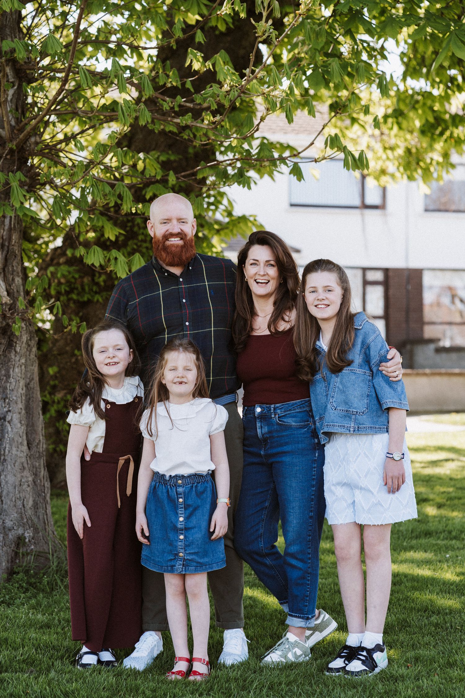 Family portrait session showing cropped views of legs and feet arranged in a creative composition outdoors.