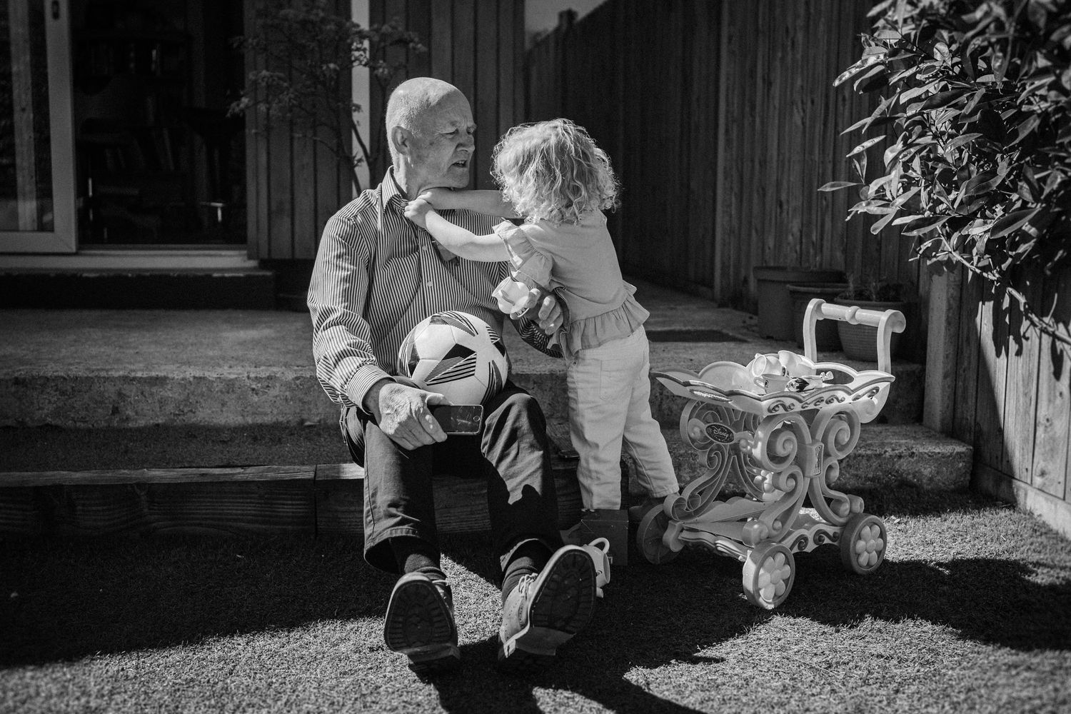 A collection of black and white outdoor photos showing people interacting in a garden or backyard setting.