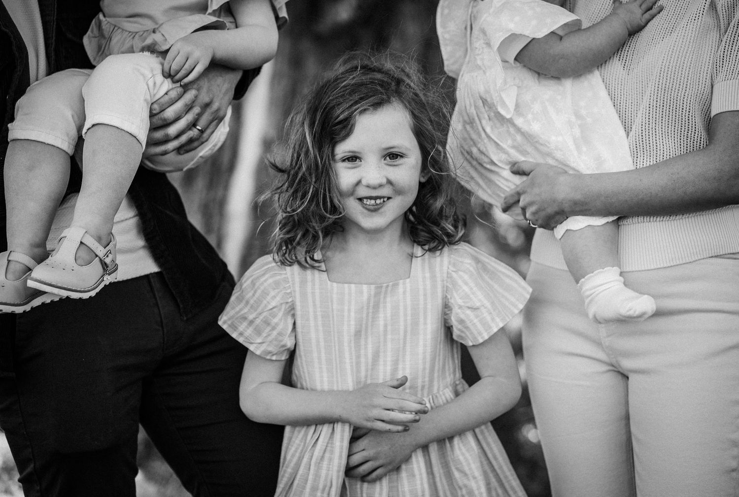 A series of black and white photographs showing candid moments at a wedding celebration.
