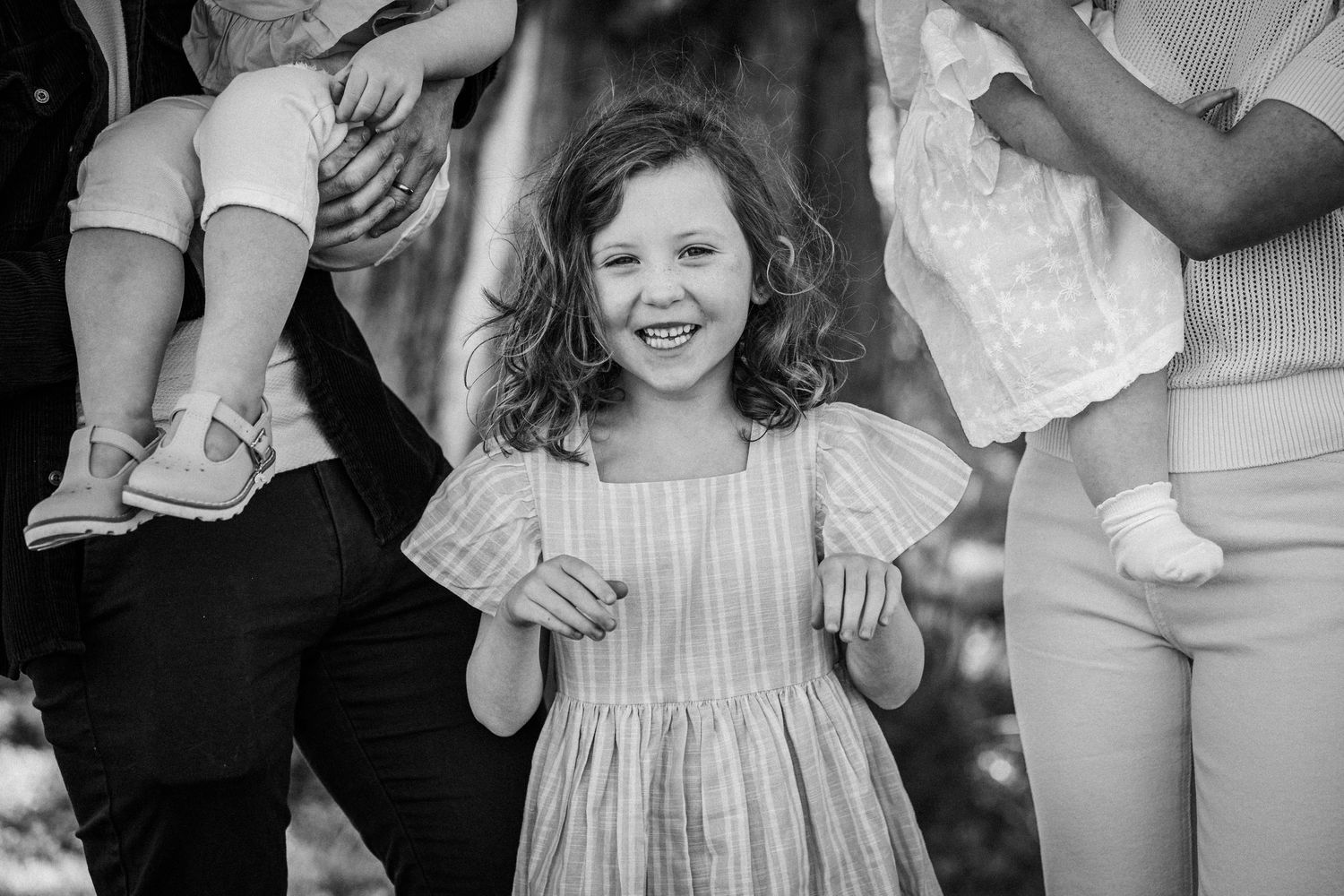 A collage of black and white photographs showing candid moments and interactions between people at a gathering.