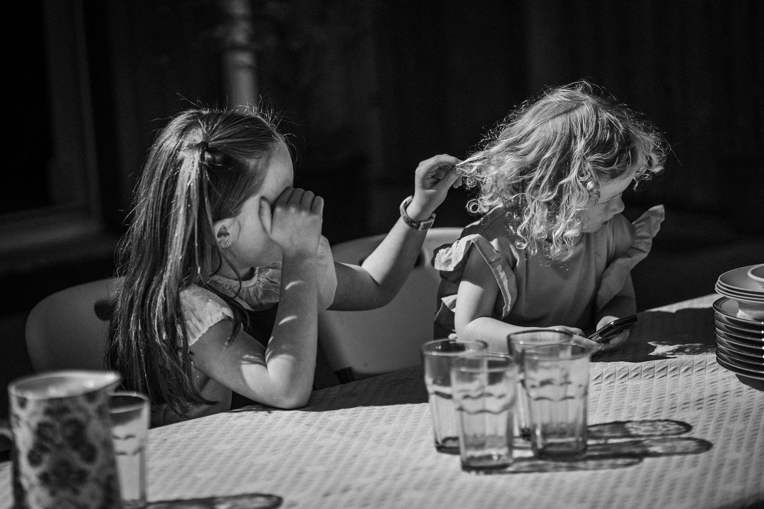 A series of black and white photos showing people sleeping with their heads down on tables and desks.