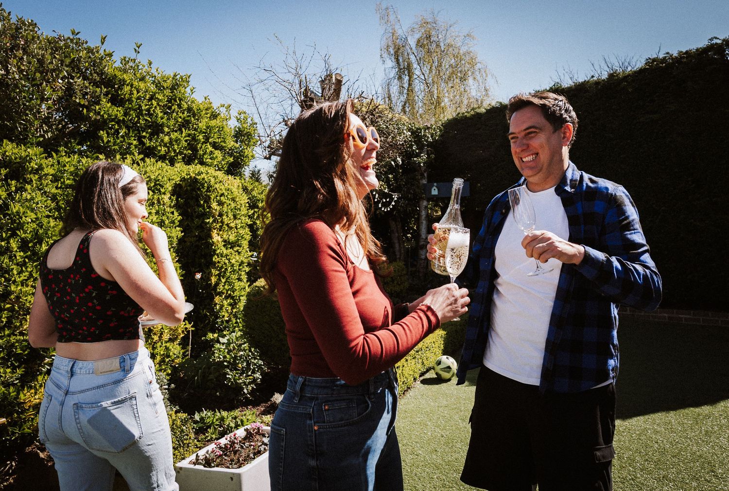 A sequence of dance moves captured in a sunny outdoor garden setting.