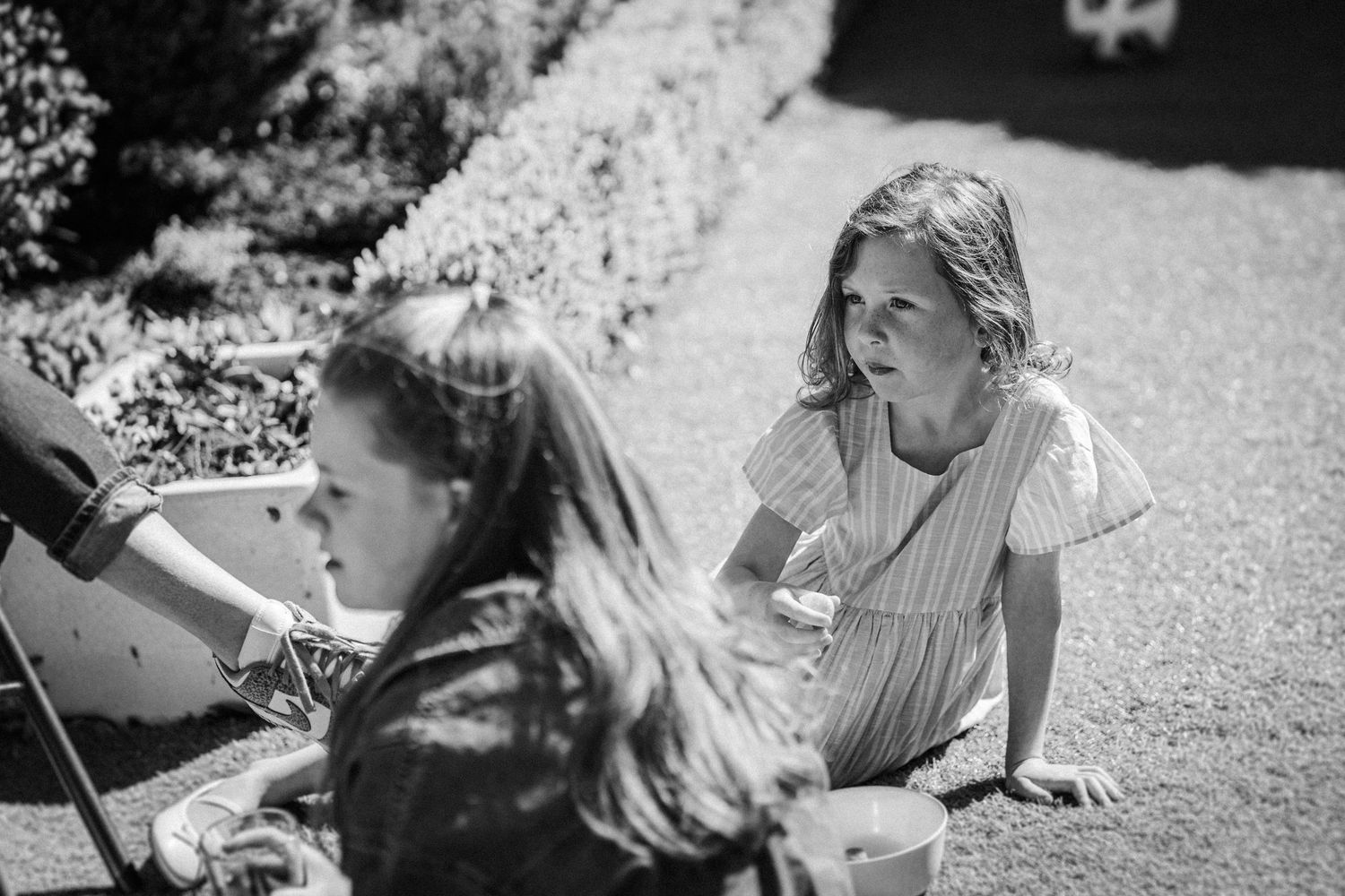 Black and white photo series showing intimate moments between people outdoors in a natural setting.