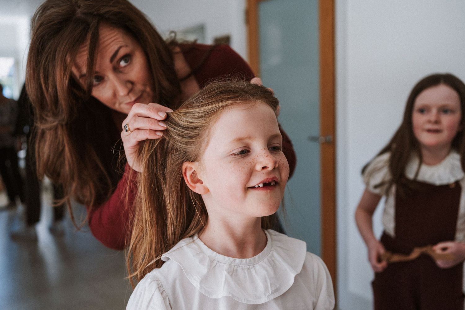 A series of candid photos showing children dancing and playing together in a bright indoor space.
