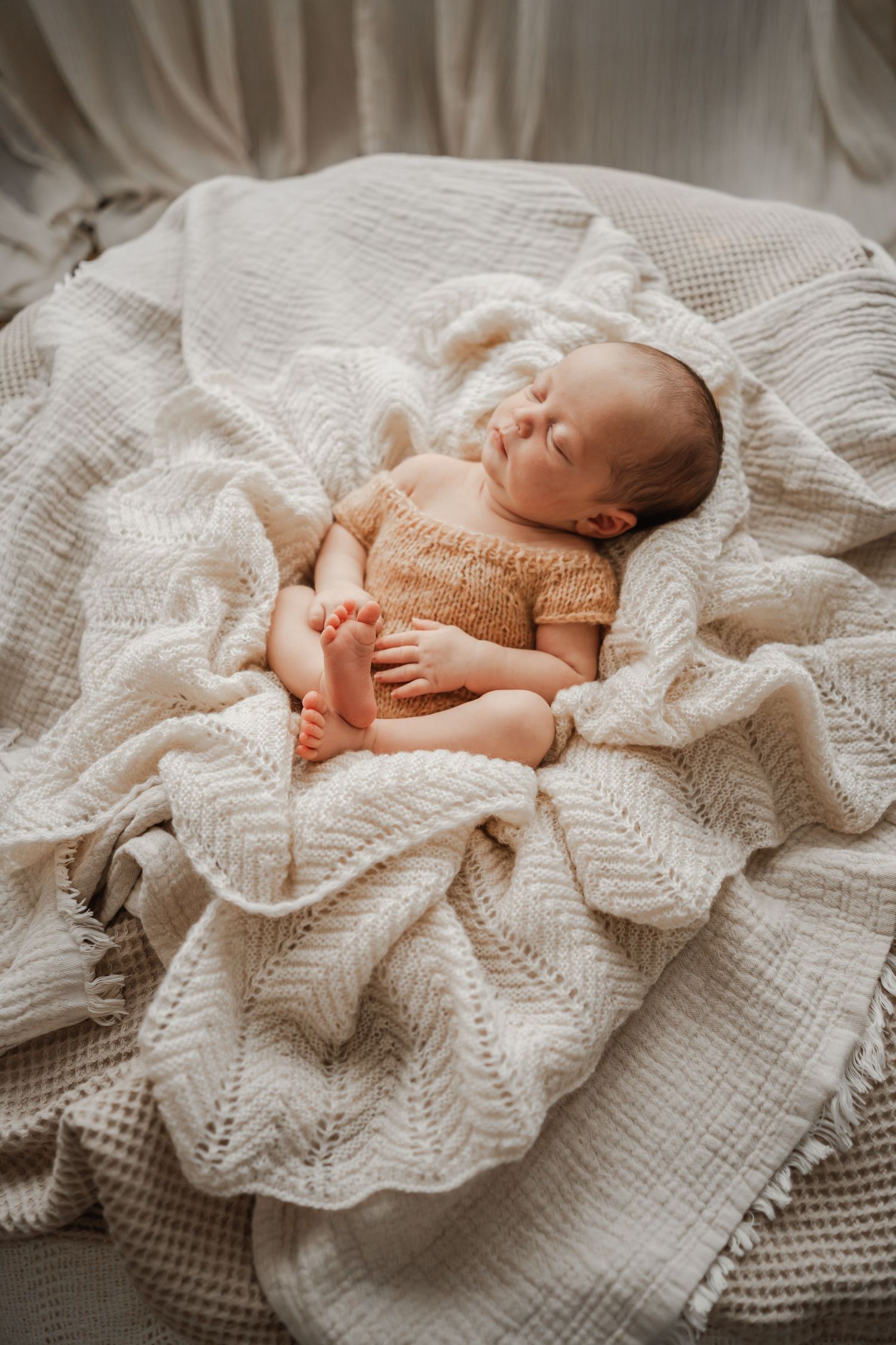 A cosy baby girl sleeping peacefully for her newborn photographer during her in-home session based in Portland, Dorset