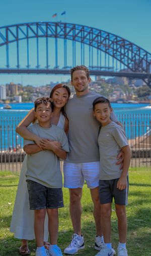 A family of four with the Sydney Harbour Bridge in the background
