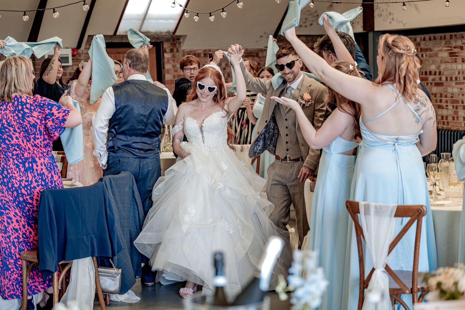 Natural guest reactions during couples wedding entrance.