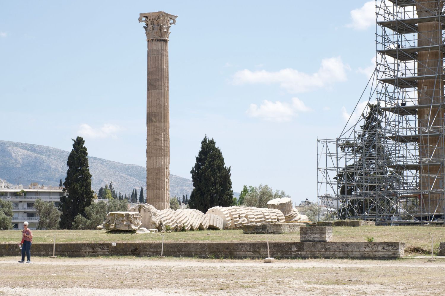 Ancient Greek columns stand against a blue sky at the Temple of Zeus in Athens, Greece.