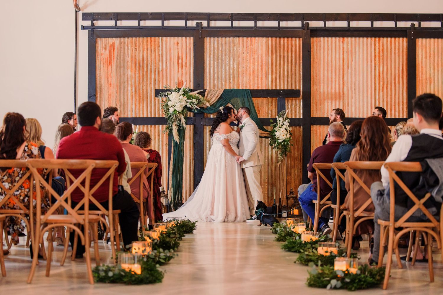 Black and white wedding photos showing a bride in a flowing white dress with a long veil in an elegant hallway setting.