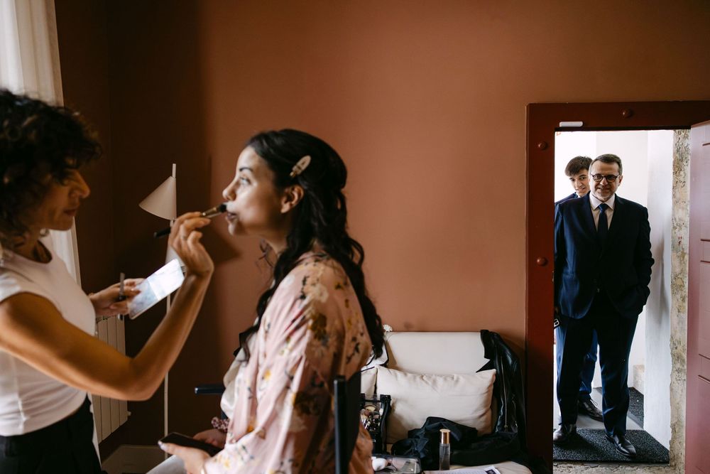 bride doing her makeup before emotional first touch during a wedding in lisbon