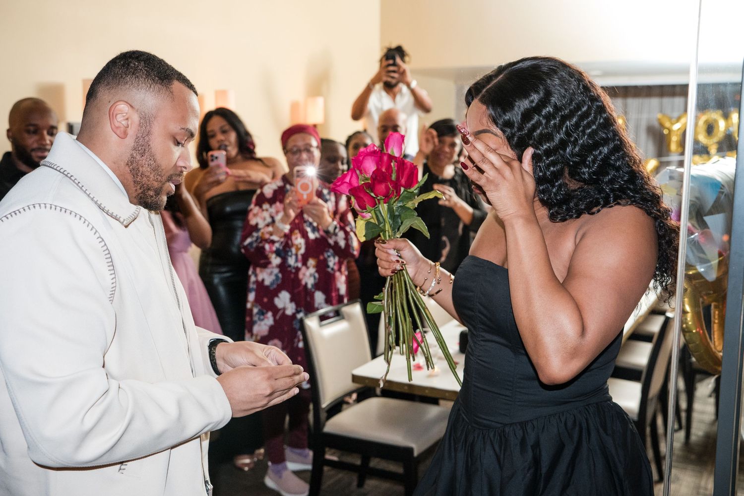 Emotional moment captured during a special celebration with guests reacting joyfully.