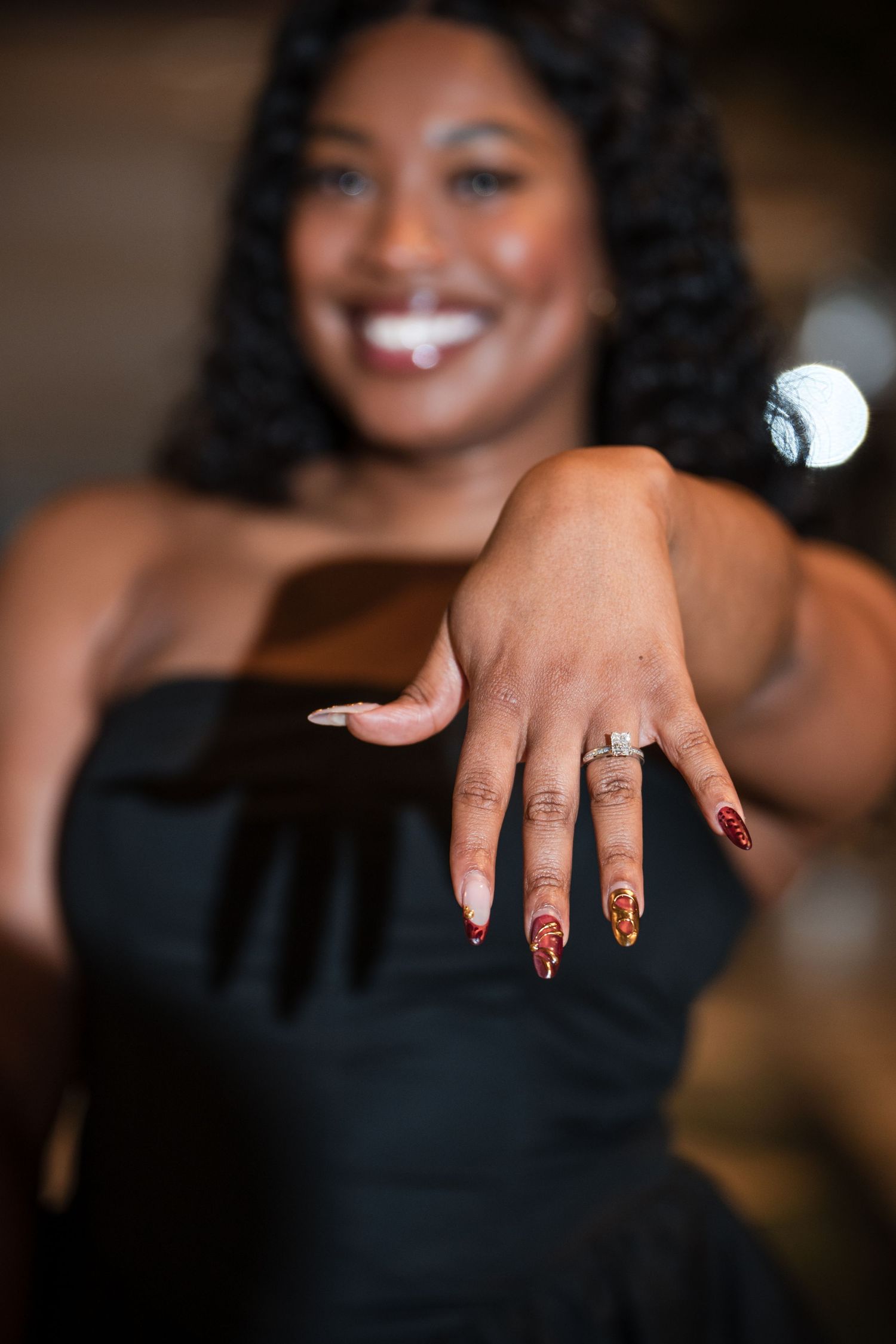 A sequence of photos showing manicured hands with leopard print nail art and delicate rings against a dark background.