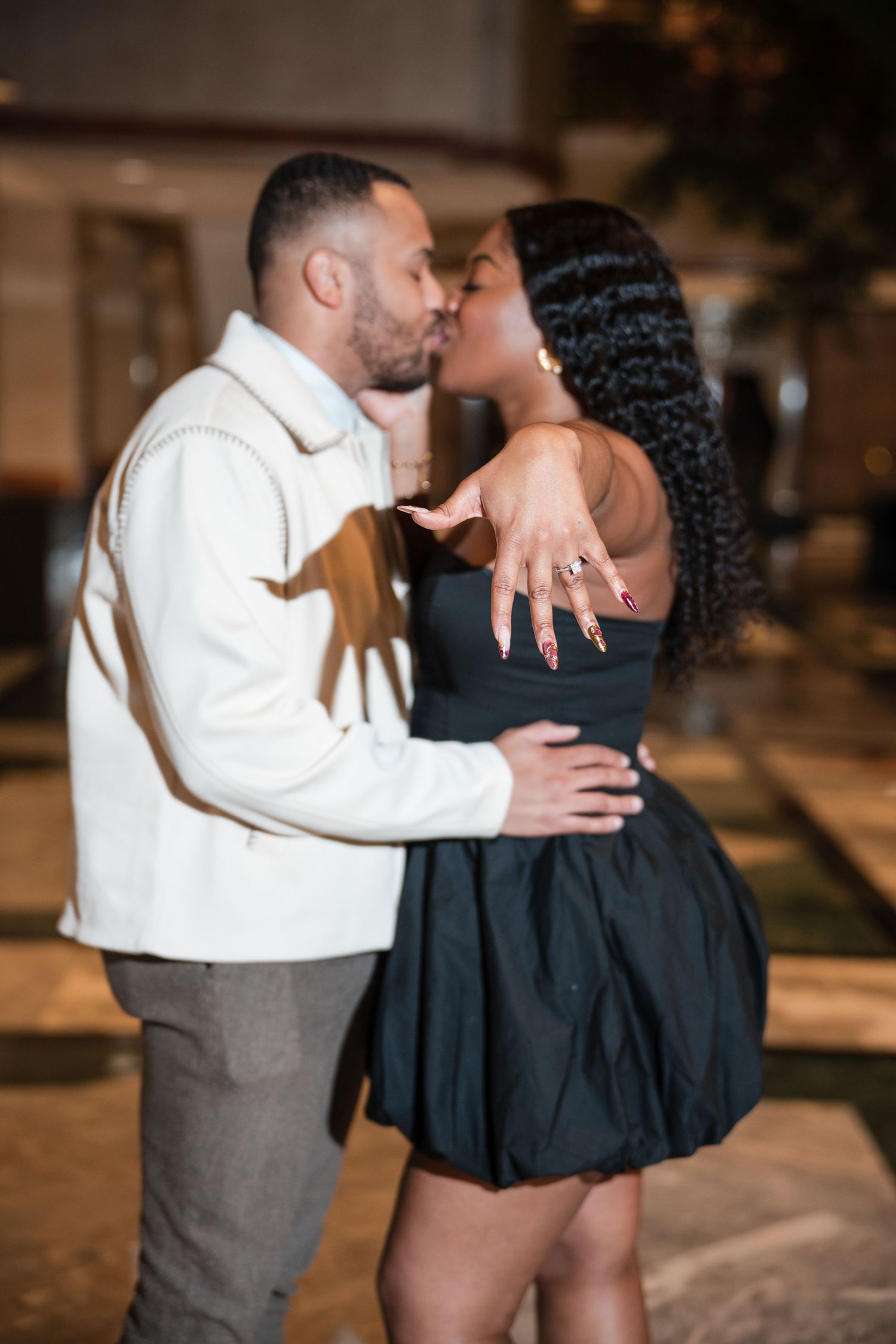 Romantic couple sharing an intimate dance moment in an elegant restaurant setting.