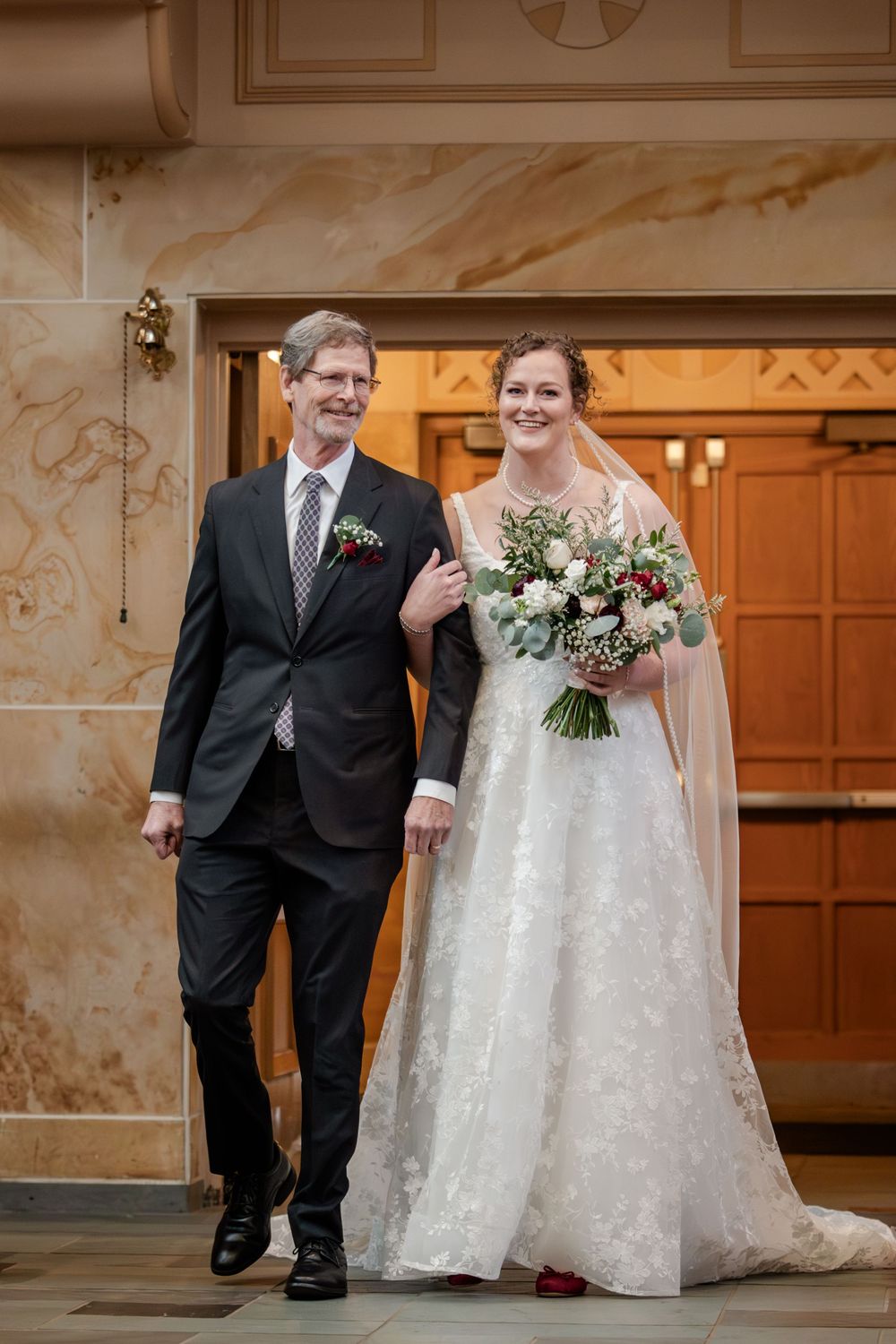 A couple in wedding attire walks together in a formal venue hallway, captured in a series of candid moments.