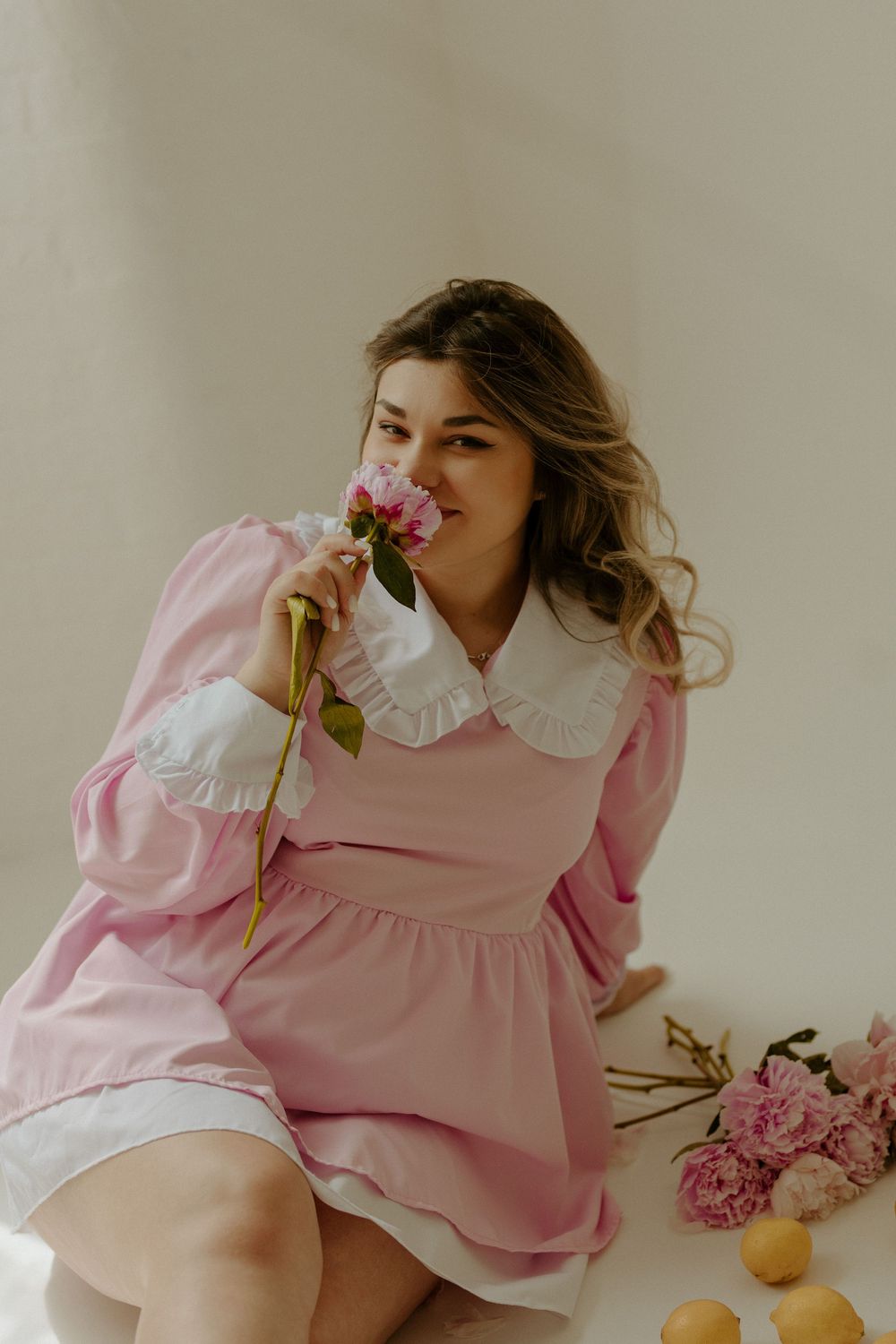 A dreamy fashion editorial series in pink featuring a romantic vintage-inspired dress and delicate flowers.
