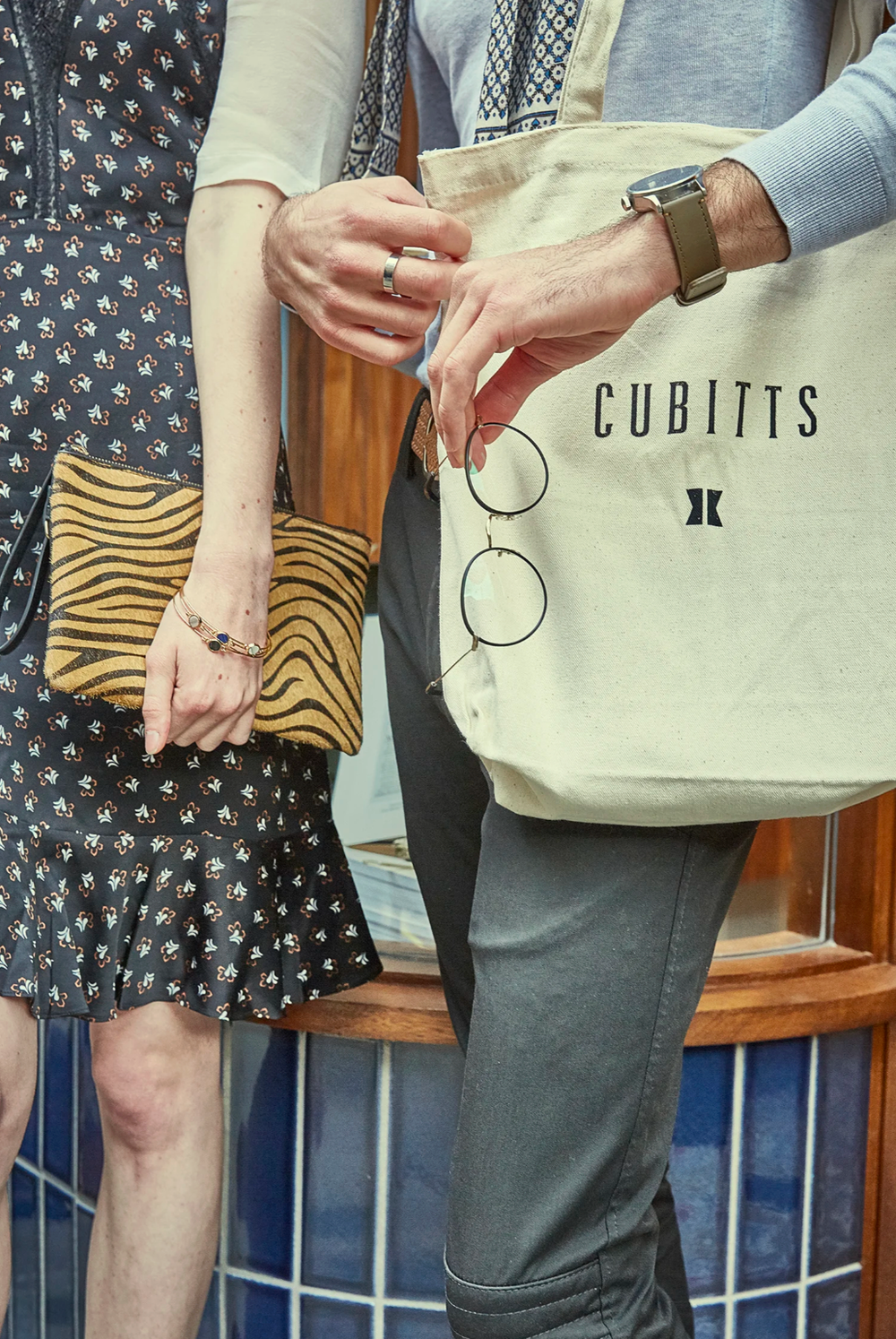 Shopping bags and accessories shown in detail against patterned clothing backgrounds.