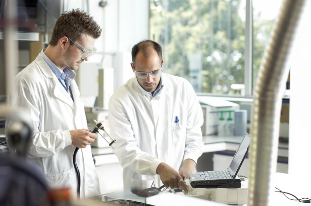 Medical professionals collaborating on research in a clinical laboratory environment.