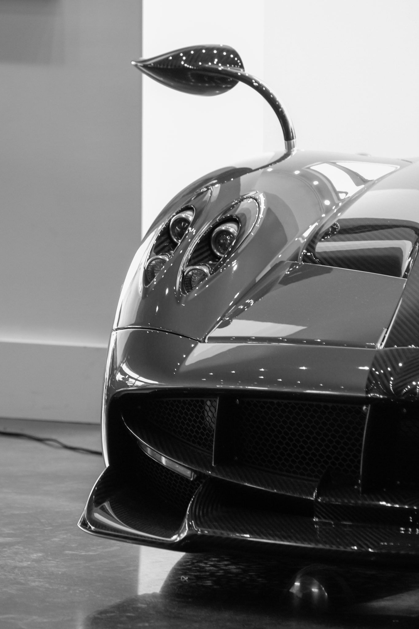 Close-up detail shots of a sleek black Ferrari LaFerrari supercar showcasing its aerodynamic design elements.