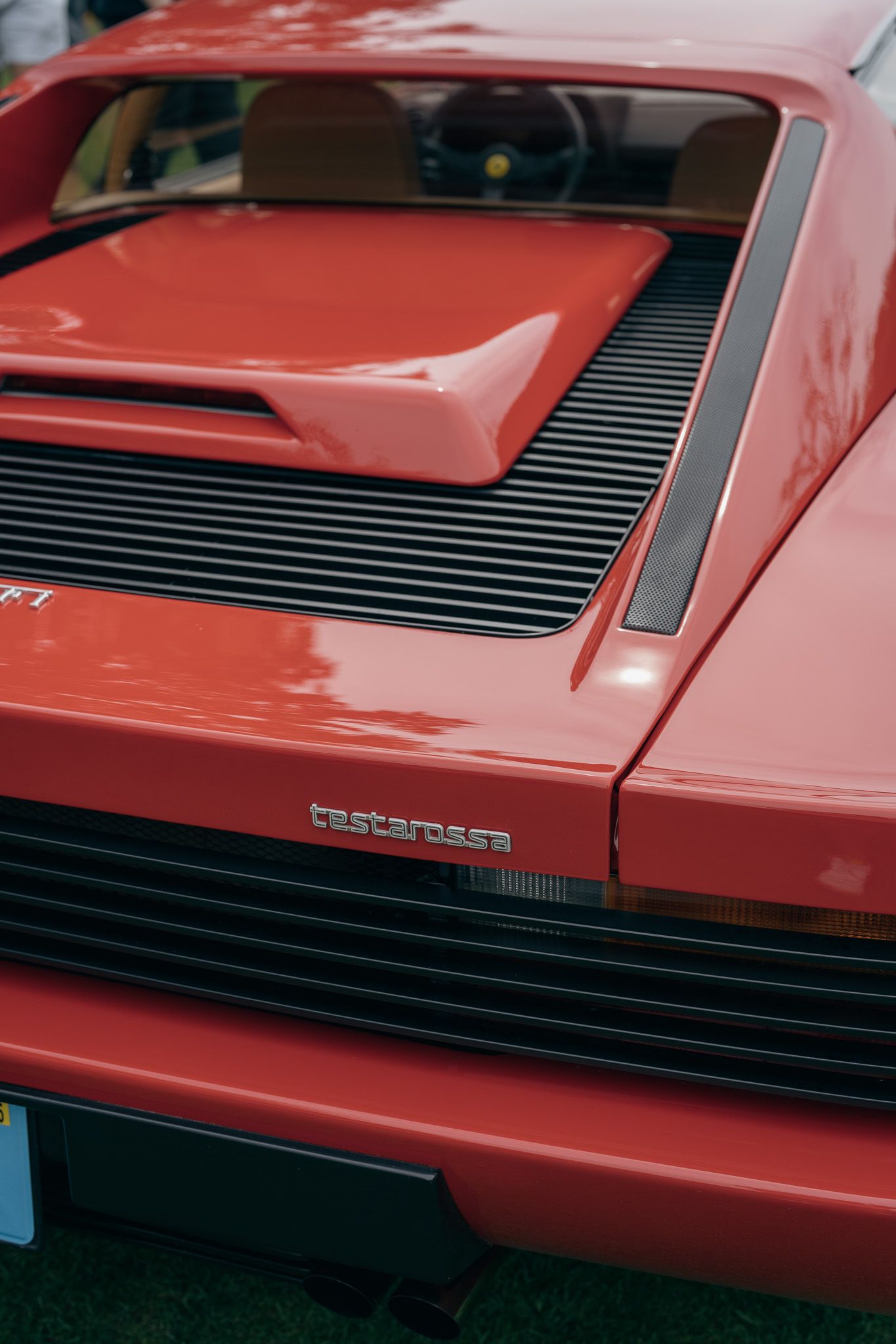 Close-up detail shots of a red Porsche 911 showing the distinctive rear engine cooling vents and body lines.