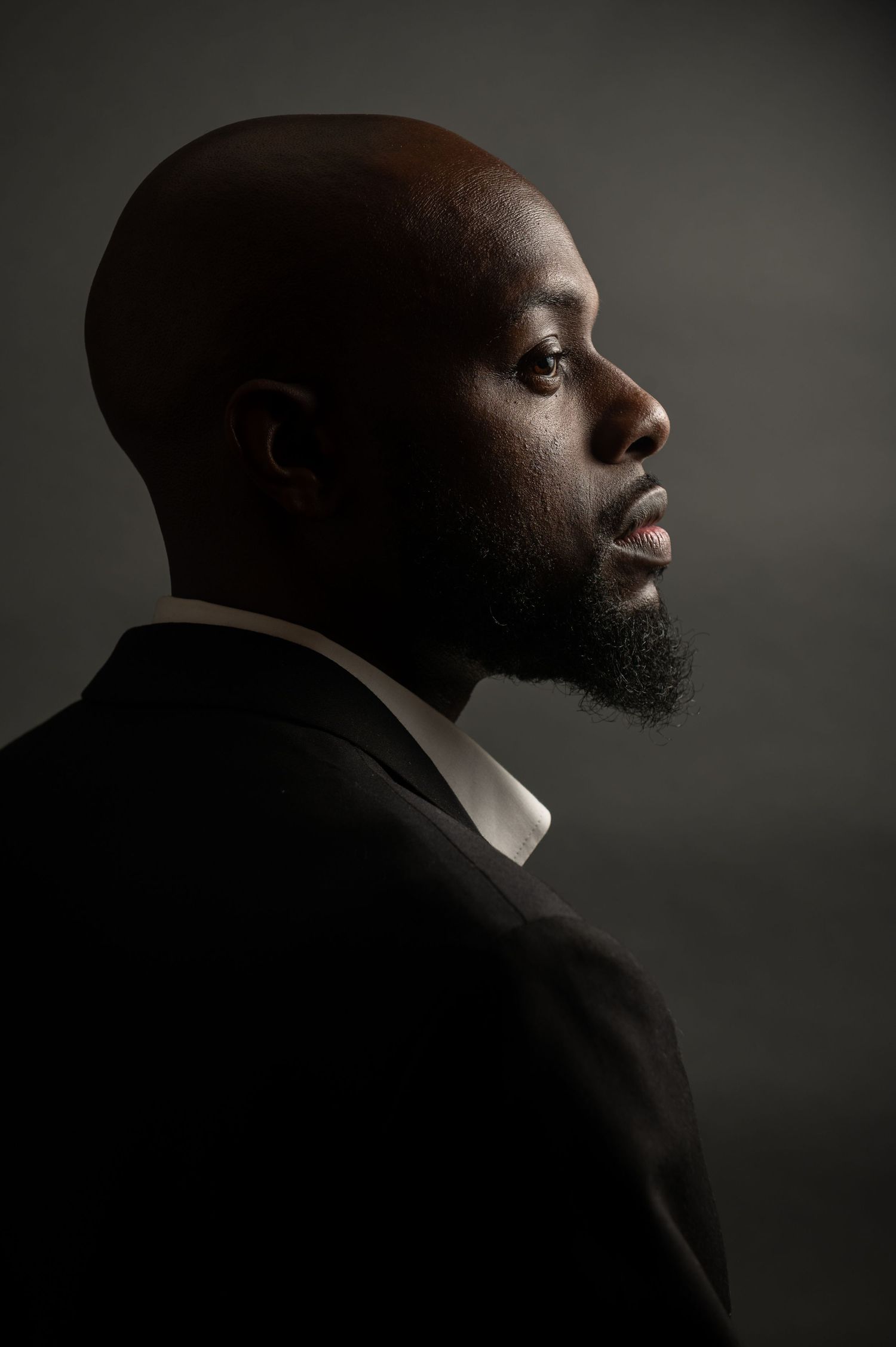 A dramatic profile portrait series showing different angles in moody lighting against a dark background.
