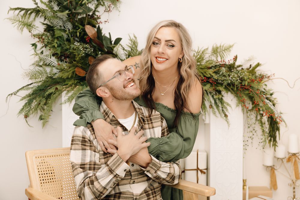 Christmas pictures of a happy couple the man smiling at his wife posing for a picture in a Colorado studio