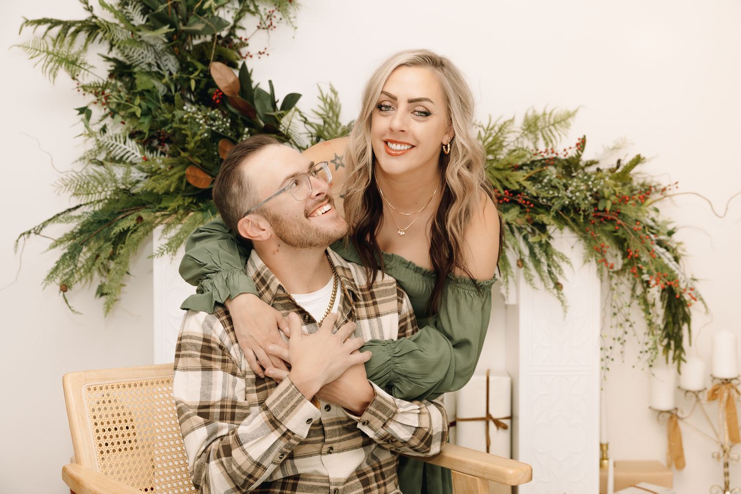 Christmas pictures of a happy couple the man smiling at his wife posing for a picture in a Colorado studio