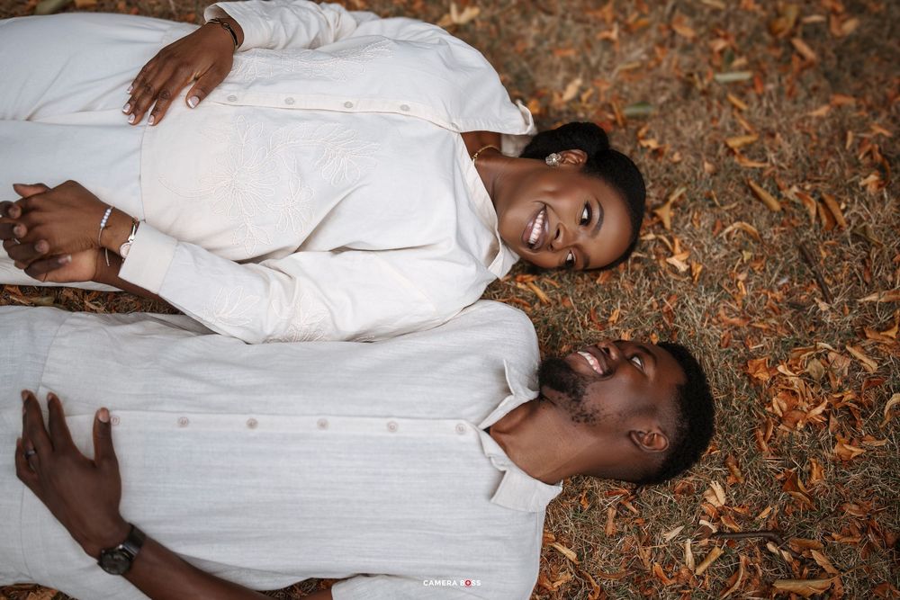 A creative photo series showing a couple in white clothing lying on autumn leaves during a photoshoot.
