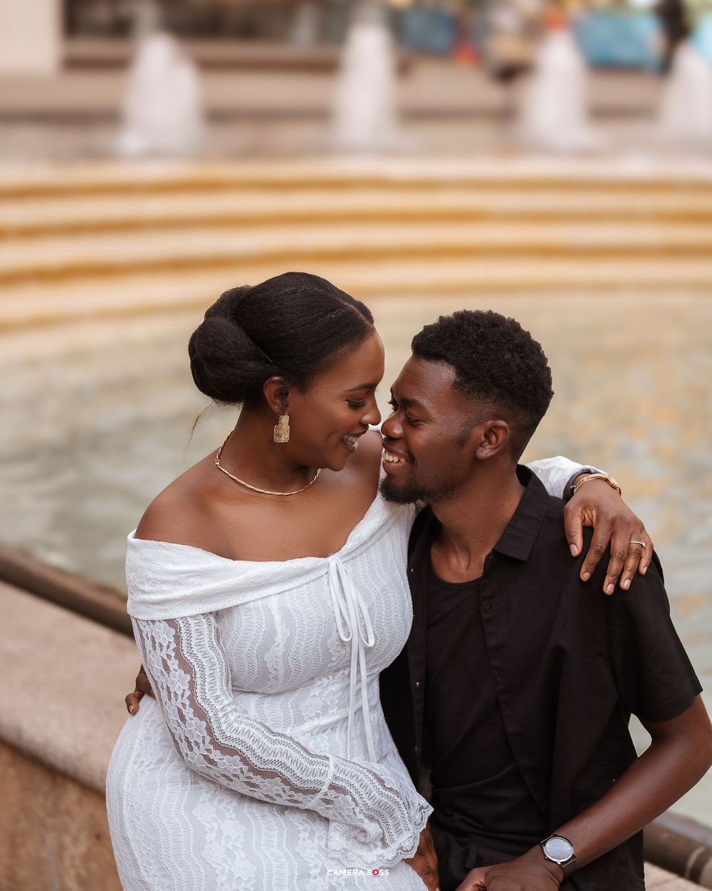 Romantic couple in white and black outfits share intimate moments in a series of outdoor portrait photos.