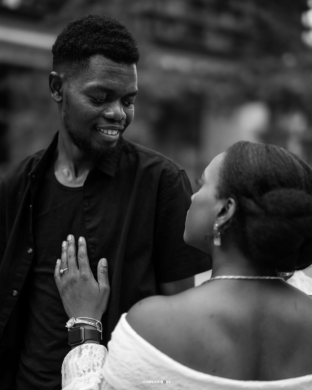 A romantic black and white photo sequence showing a couple sharing joyful moments and laughter together.