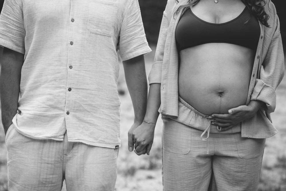 Side-by-side maternity portraits in casual white and dark clothing.