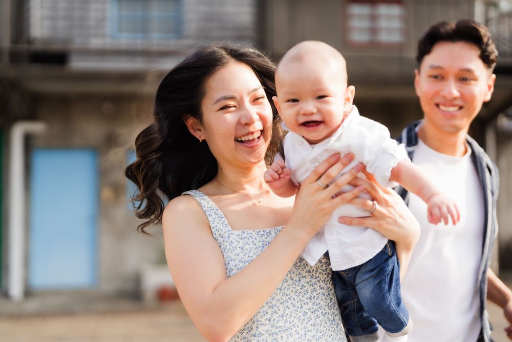 A happy family shares joyful moments together in a series of candid outdoor portraits.